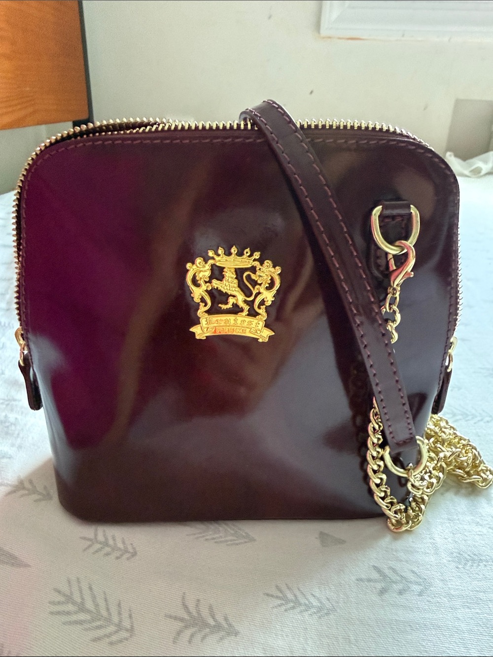 Women's Burgundy Chain Crossbody Bag with Gold Emblem